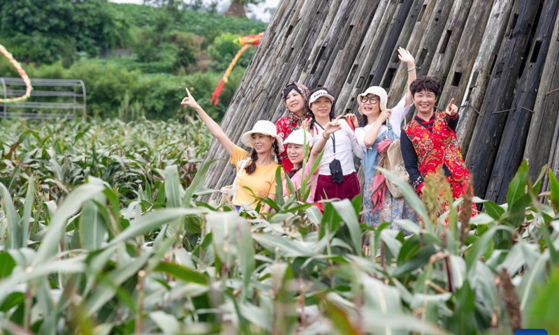 Tourists pose for a group photo during a rural art fair in Jiangjun Village, Bishan District, southwest China's Chongqing Municipality, Sept. 29, 2025. Photo: Xinhua