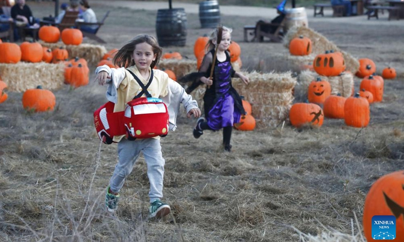 Young girls in festive attire attend the Nightfall event at the Filoli Historic House & Garden in Woodside, California, the United States, Oct. 3, 2025. The second Nightfall opened here on Friday and will last till Nov. 10. (Photo by Liu Yilin/Xinhua)

