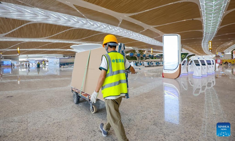 A worker transports gypsum boards at the T3 Terminal of Guangzhou Baiyun International Airport in Guangzhou, south China's Guangdong Province, Sept. 29, 2025. Photo: Xinhua