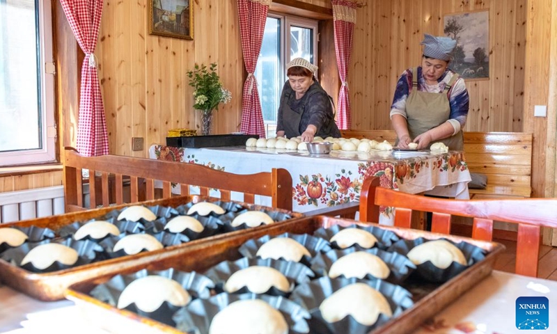 Sun Yunmei (L) and her niece Sun Jinyan knead dough for making bread in Enhe, a Russian ethnic township in Hulun Buir City, north China's Inner Mongolia Autonomous Region, on Sept. 26, 2025. 
