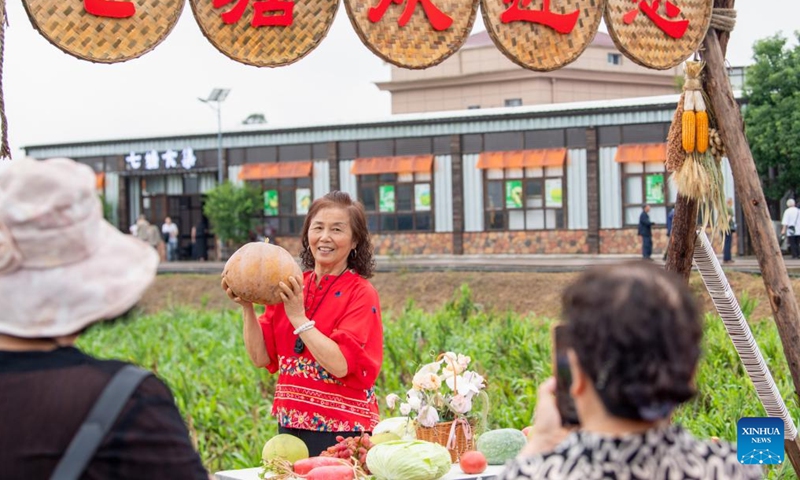 A visitor poses for a photo during a rural art fair in Jiangjun Village, Bishan District, southwest China's Chongqing Municipality, Sept. 29, 2025. Photo: Xinhua