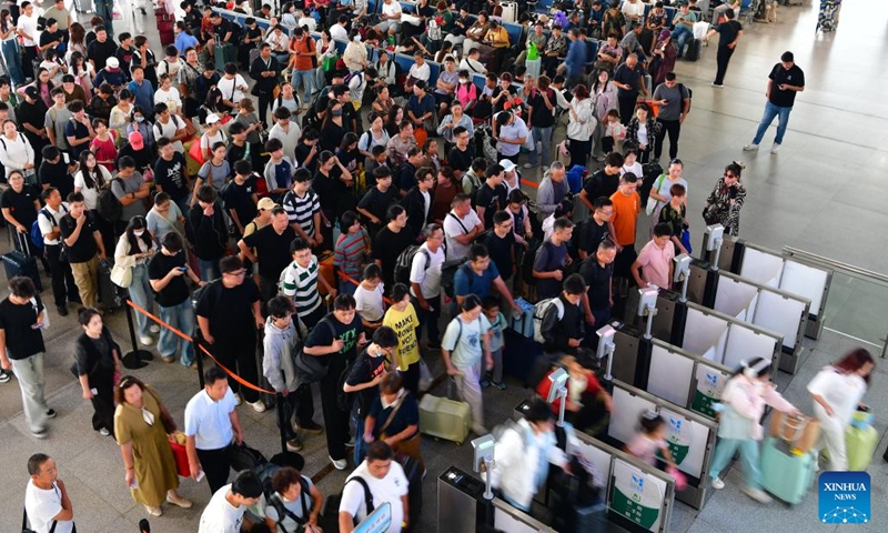 Passengers queue to have their tickets checked at Wuxi Railway Station in Wuxi, east China's Jiangsu Province, Sept. 29, 2025. China's National Day holiday travel rush started on Sept. 29 and will last until Oct. 10. Photo: Xinhua