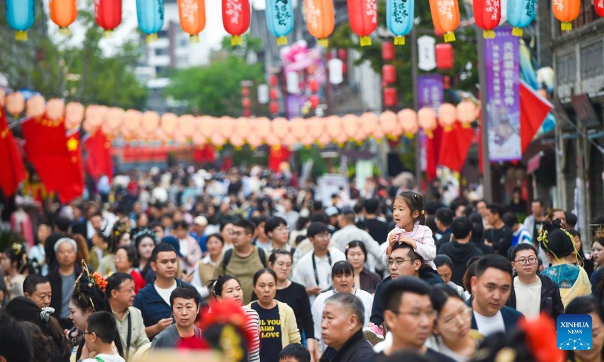 Tourists are seen at a cultural and historical scenic spot in Luoyang City, central China's Henan Province, Oct. 2, 2025. Tourist destinations across China are witnessing a surge in visitors as the country's eight-day National Day and Mid-Autumn Festival holiday began on Wednesday. (Photo by Huang Zhengwei/Xinhua)

