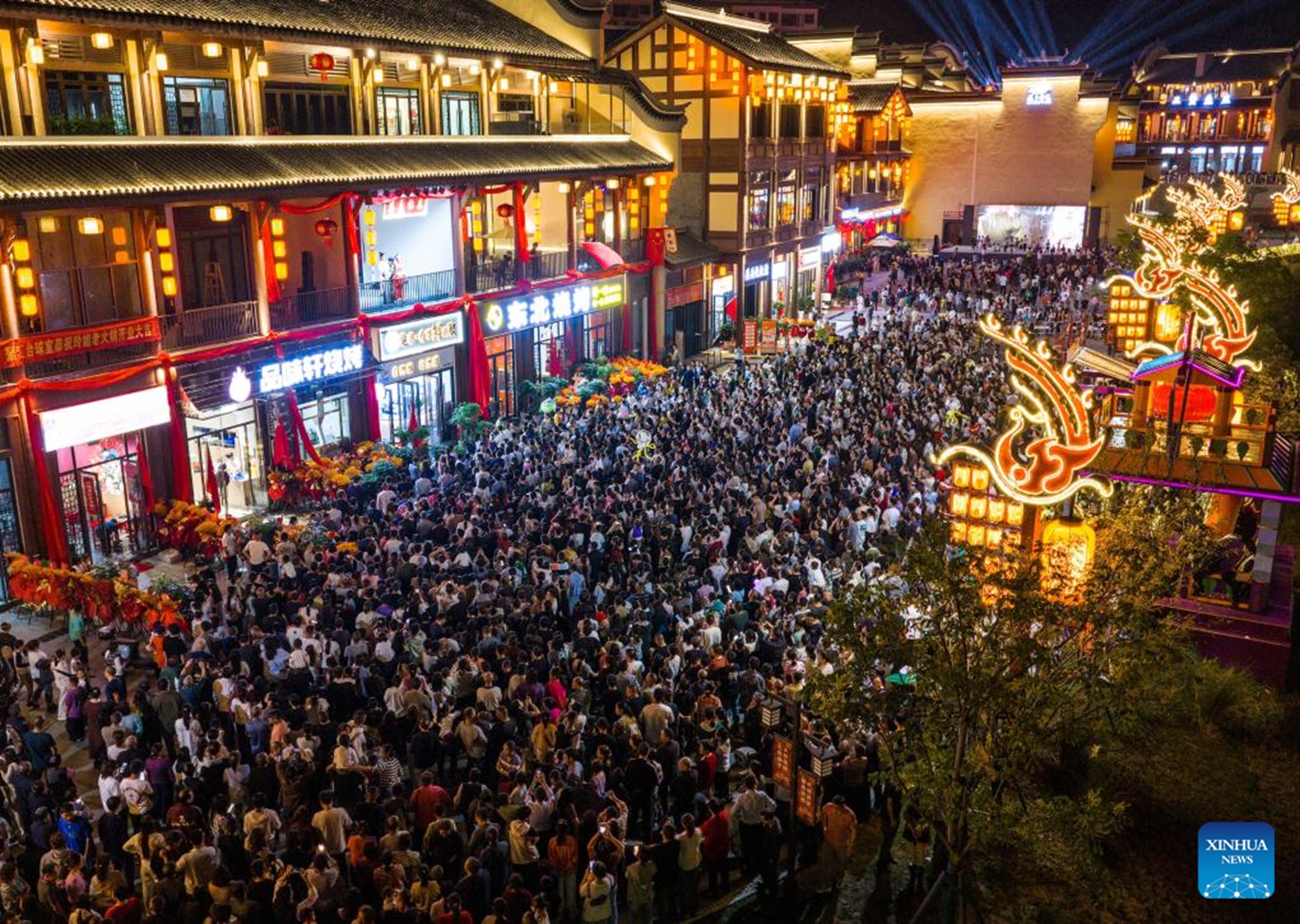 A drone photo taken on Oct. 1, 2025 shows people visiting a scenic spot in Zigui County, central China's Hubei Province. Tourist destinations across China are witnessing a surge in visitors as the country's eight-day National Day and Mid-Autumn Festival holiday began on Wednesday. (Photo by Wang Gang/Xinhua)

