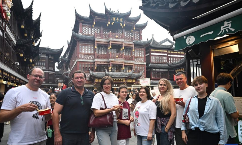 Tourists from Russia pose for photos at Yuyuan Garden Mall in east China's Shanghai, Oct. 3, 2025. The eastern Chinese megacity of Shanghai received a whopping 4.1 million overseas visitors from January to August this year.(Xinhua/Chen Haoming)