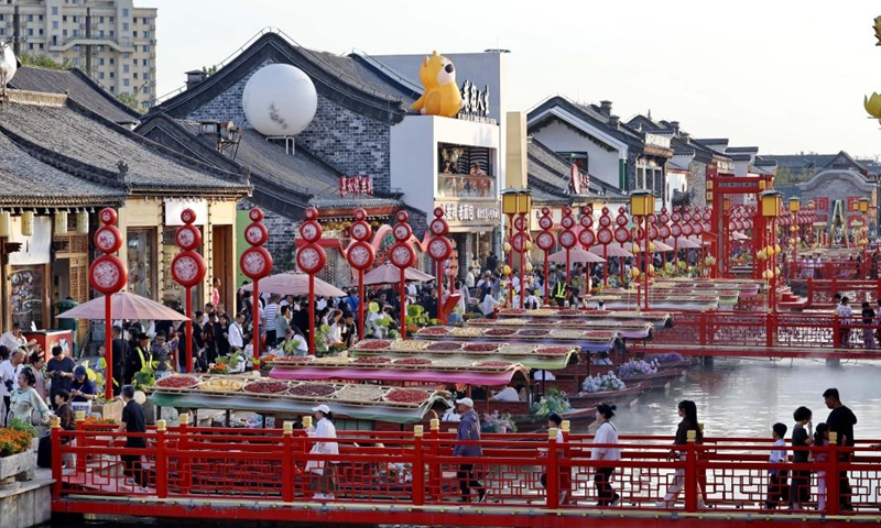 An aerial drone photo taken on Oct. 3, 2025 shows tourists enjoying a molten iron fireworks show at a scenic area in Tancheng County of Linyi City, east China's Shandong Province. Tourist destinations across China are witnessing a surge in visitors as the country's eight-day National Day and Mid-Autumn Festival holiday began on Wednesday. (Photo by Zhang Chunlei/Xinhua)