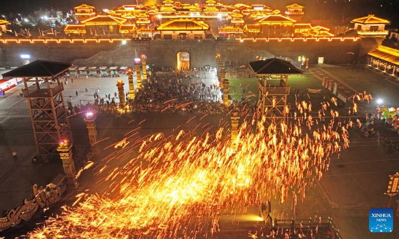 An aerial drone photo taken on Oct. 3, 2025 shows tourists enjoying a molten iron fireworks show at a scenic area in Tancheng County of Linyi City, east China's Shandong Province. Tourist destinations across China are witnessing a surge in visitors as the country's eight-day National Day and Mid-Autumn Festival holiday began on Wednesday. (Photo by Zhang Chunlei/Xinhua)