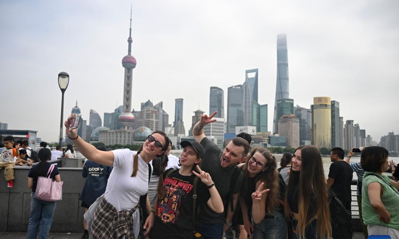 Tourists from Russia take selfies at the Bund area in east China's Shanghai, Oct. 4, 2025. The eastern Chinese megacity of Shanghai received a whopping 4.1 million overseas visitors from January to August this year.

The latest tourism boom in the city has resulted from a series of policies that provide greater convenience for international tourists entering China. As one of the country's most famous tourist cities, Shanghai is usually among the first places affected by new policies for the sector. (Xinhua/Chen Haoming)