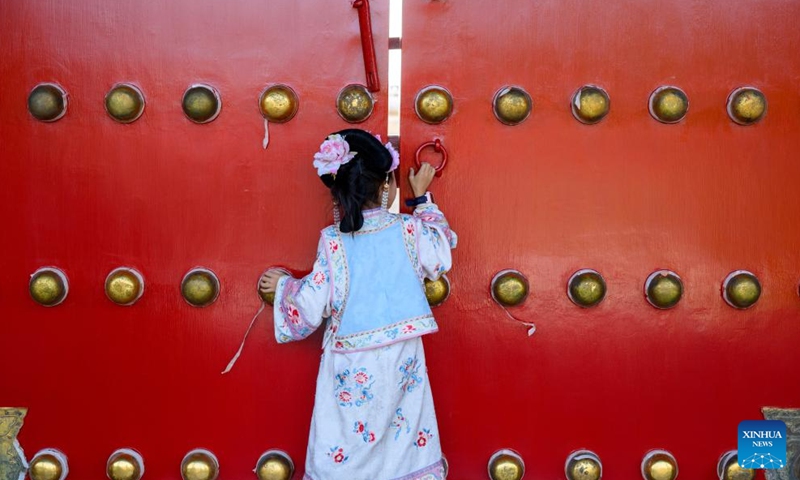 A little girl in traditional costumes is pictured at the Palace Museum in Beijing, capital of China, Oct. 2, 2025. This year marks the 100th anniversary of the founding of China's Palace Museum, also known as the Forbidden City.(Xinhua/Jin Liangkuai)