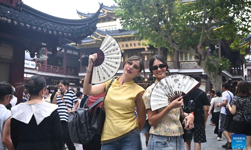 Shuanet (L) and Lolita from Russia pose for photos at Yuyuan Garden Mall in east China's Shanghai, Oct. 3, 2025. The eastern Chinese megacity of Shanghai received a whopping 4.1 million overseas visitors from January to August this year.(Xinhua/Chen Haoming)
