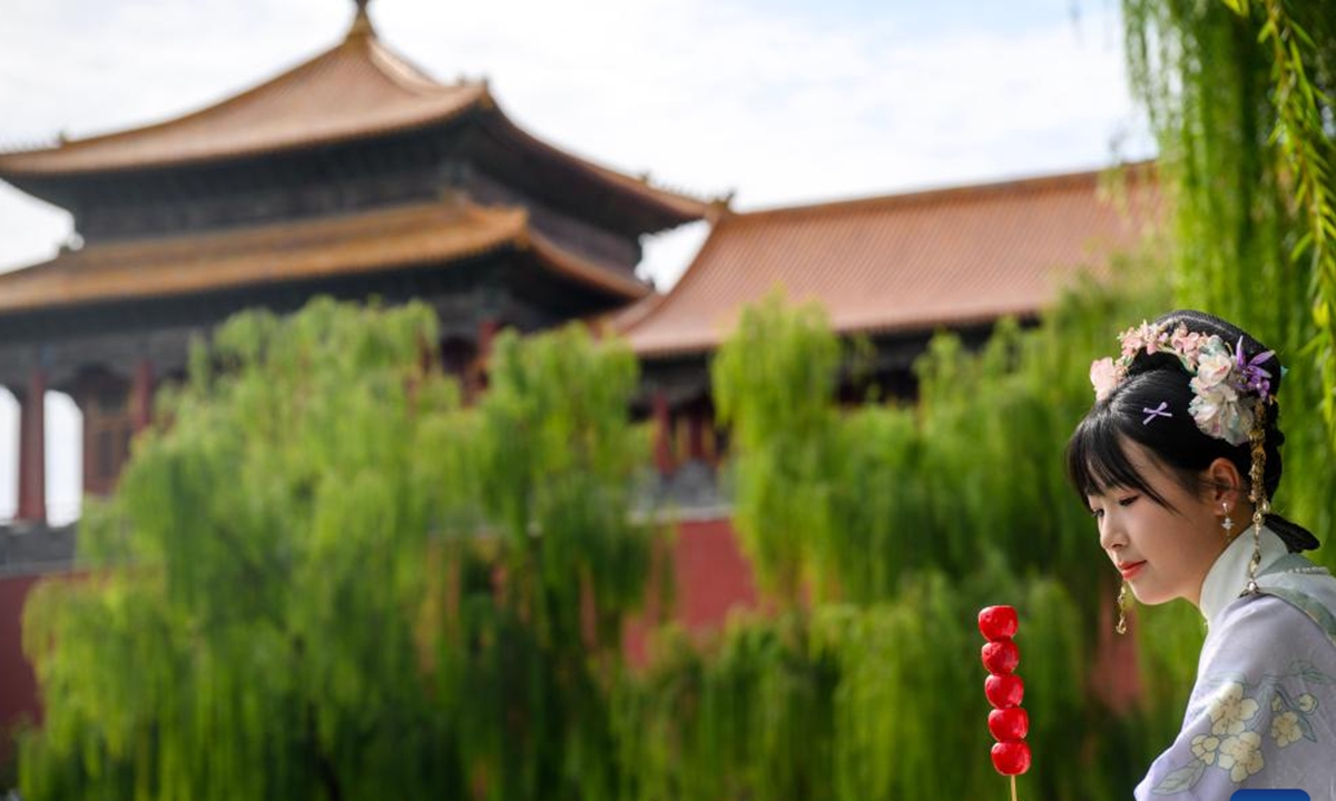 A tourist in traditional costumes is pictured outside the Palace Museum in Beijing, capital of China, Oct. 2, 2025. This year marks the 100th anniversary of the founding of China's Palace Museum, also known as the Forbidden City.(Xinhua/Jin Liangkuai)