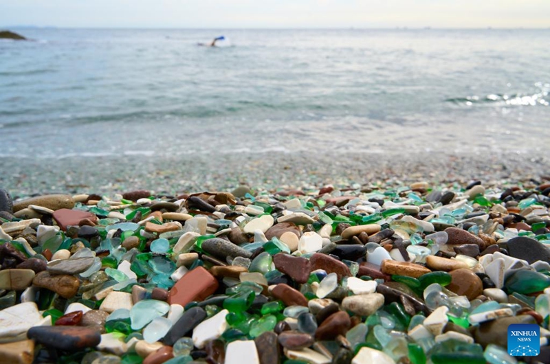 This photo taken on Oct. 5, 2025 shows a view of Glass Beach in Vladivostok, Russia. Located in Ussuri Bay on the outskirts of Vladivostok, Glass Beach was once a dumping site for discarded glassware. After decades of being washed by the sea, the glass fragments have been polished into smooth, colorful pebbles, creating a vibrant shoreline that attracts large number of tourists. (Photo by Guo Feizhou/Xinhua)