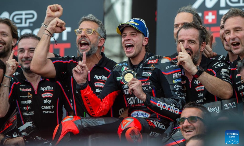 Italian rider Marco Bezzecchi (C) of Aprilia Racing celebrates with his team after the awarding ceremony of the Sprint Race of MotoGP at the Pertamina Grand Prix of Indonesia 2025 in Lombok Island, Indonesia on Oct. 4, 2025. Photo: Xinhua