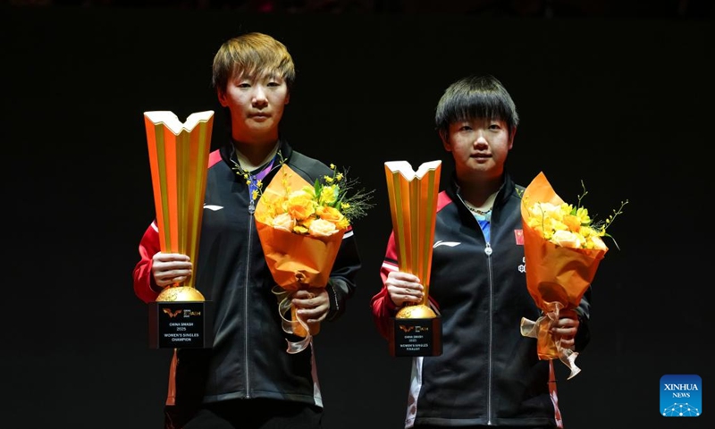 Winner Wang Manyu (L) and runner-up Sun Yingsha of China pose during the awarding ceremony for the women's singles event at 2025 World Table Tennis (WTT) China Smash in Beijing, China, Oct. 5, 2025. (Xinhua/Sun Fei)