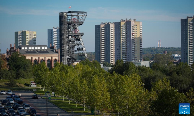 This photo taken on Oct. 4, 2025 shows an old mine shaft tower alongside modern high-rise buildings in Katowice, Poland. Katowice, the capital of Poland's Silesian region, once known for its heavy industry, is now revitalizing itself through modern architecture and creative industries. (Photo by Jaap Arriens/Xinhua)