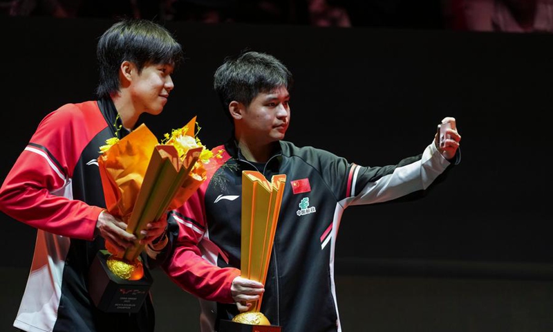 Wang Chuqin (L) and Lin Shidong pose during the trophy ceremony after the men's doubles final against Zhou Qihao and Chen Junsong at 2025 World Table Tennis (WTT) China Smash in Beijing, China, Oct. 4, 2025. (Xinhua/Sun Fei)