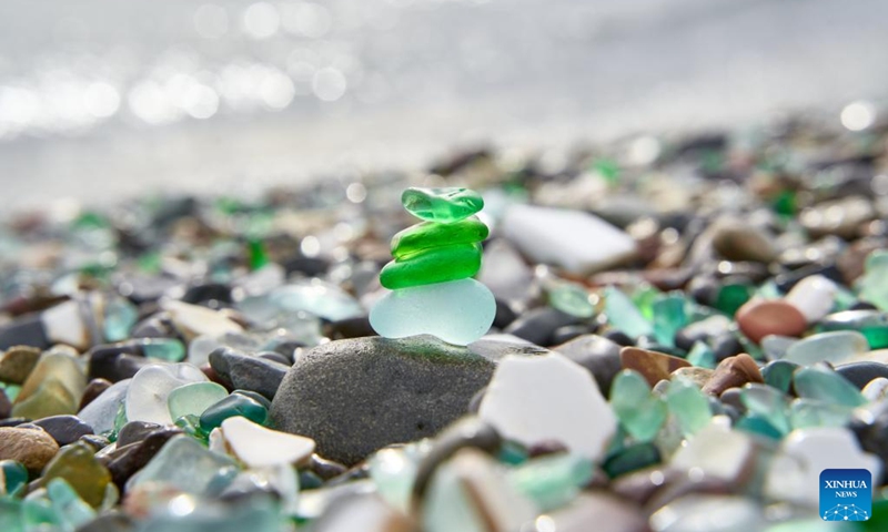 This photo taken on Oct. 5, 2025 shows a view of Glass Beach in Vladivostok, Russia. Located in Ussuri Bay on the outskirts of Vladivostok, Glass Beach was once a dumping site for discarded glassware. After decades of being washed by the sea, the glass fragments have been polished into smooth, colorful pebbles, creating a vibrant shoreline that attracts large number of tourists. (Photo by Guo Feizhou/Xinhua)