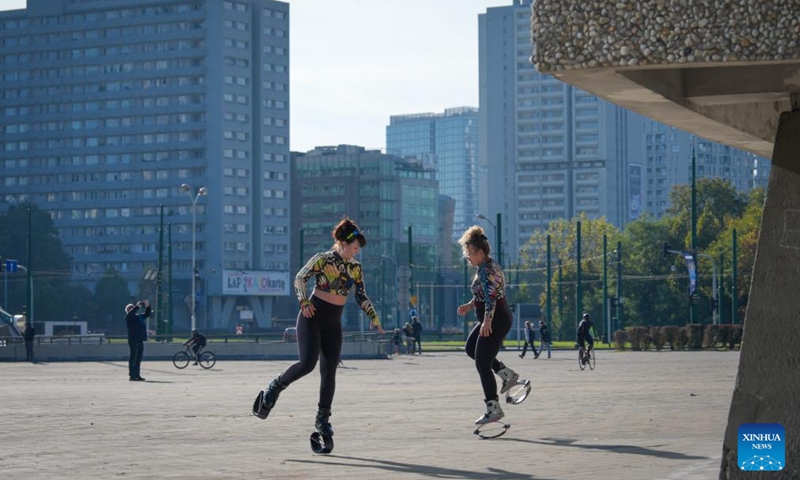 People exercise in front of the Spodek arena, a landmark in Katowice, Poland on Oct. 4, 2025. Katowice, the capital of Poland's Silesian region, once known for its heavy industry, is now revitalizing itself through modern architecture and creative industries. (Photo by Jaap Arriens/Xinhua)