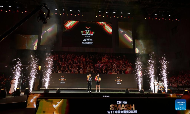 Winner for men's singles Wang Chuqin (R) of China and winner for women's singles Wang Manyu of China pose after the awarding ceremony for the men's singles event at 2025 World Table Tennis (WTT) China Smash in Beijing, China, Oct. 5, 2025. (Xinhua/Sun Fei)