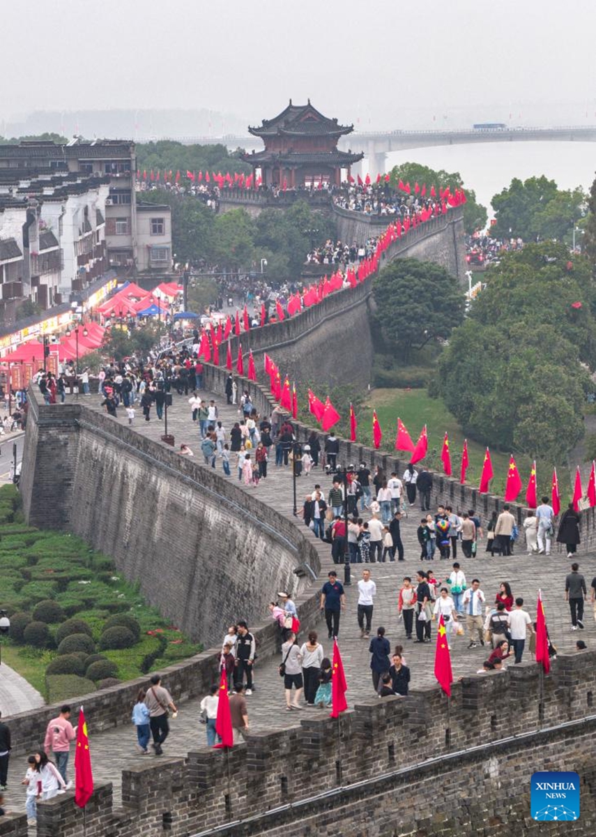 An aerial drone photo taken on Oct. 4, 2025 shows tourists visiting the Xiangyang ancient town in Xiangyang City, central China's Hubei Province. Tourist destinations across China are witnessing a surge in visitors as the country's eight-day National Day and Mid-Autumn Festival holiday began on Wednesday. Photo: Xinhua
