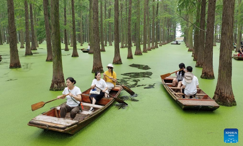 An aerial drone photo taken on Oct. 5, 2025 shows tourists rowing boats at Luyang Lake wetland park in Yangzhou, east China's Jiangsu Province. Tourist destinations across China are witnessing a surge in visitors as the country's eight-day National Day and Mid-Autumn Festival holiday began on Wednesday. Photo: Xinhua