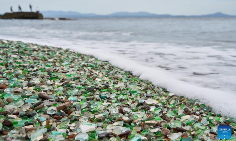 This photo taken on Oct. 5, 2025 shows a view of Glass Beach in Vladivostok, Russia. Located in Ussuri Bay on the outskirts of Vladivostok, Glass Beach was once a dumping site for discarded glassware. After decades of being washed by the sea, the glass fragments have been polished into smooth, colorful pebbles, creating a vibrant shoreline that attracts large number of tourists. (Photo by Guo Feizhou/Xinhua)