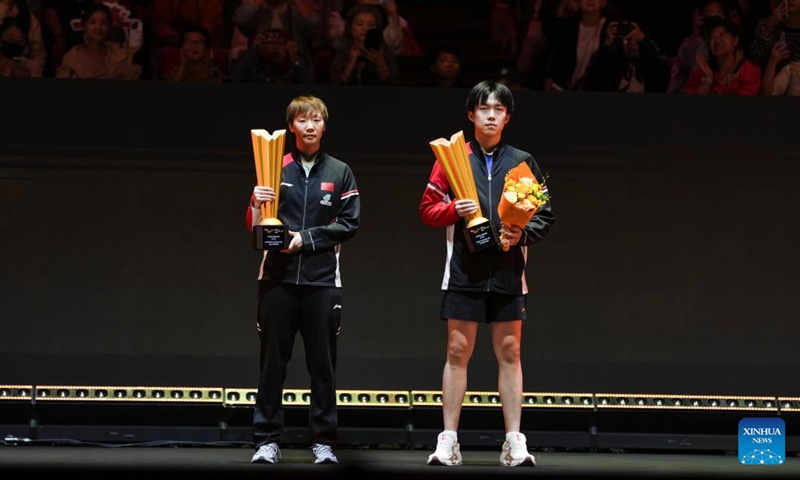 Winner for men's singles Wang Chuqin (R) of China and winner for women's singles Wang Manyu of China pose during the awarding ceremony at 2025 World Table Tennis (WTT) China Smash in Beijing, China, Oct. 5, 2025. (Xinhua/Sun Fei)