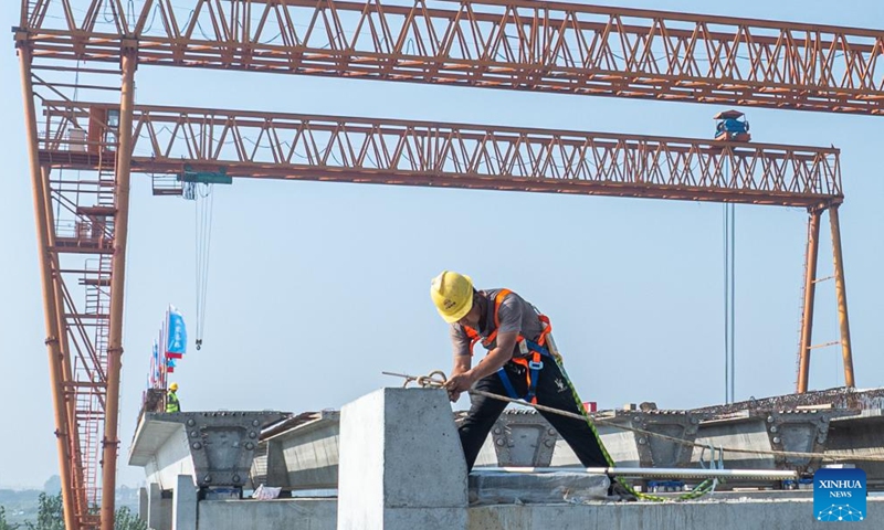 A constructor works at the construction site of a highway in Wuhan, central China's Hubei Province, Oct. 6, 2025. Many workers have been standing fast at their posts and fulfilling their duties during the eight-day National Day and Mid-Autumn Festival holiday. (Xinhua/Xiao Yijiu)

