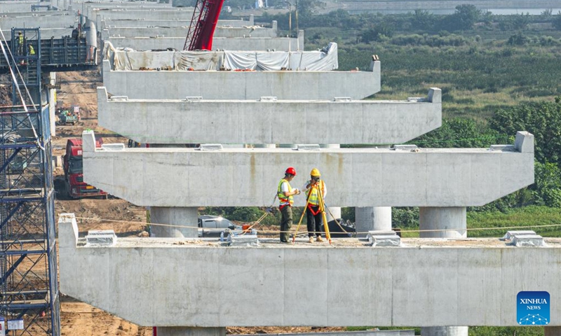 An aerial drone photo taken on Oct. 6, 2025 shows the construction site of a highway in Wuhan, central China's Hubei Province. Many workers have been standing fast at their posts and fulfilling their duties during the eight-day National Day and Mid-Autumn Festival holiday. (Xinhua/Xiao Yijiu)

