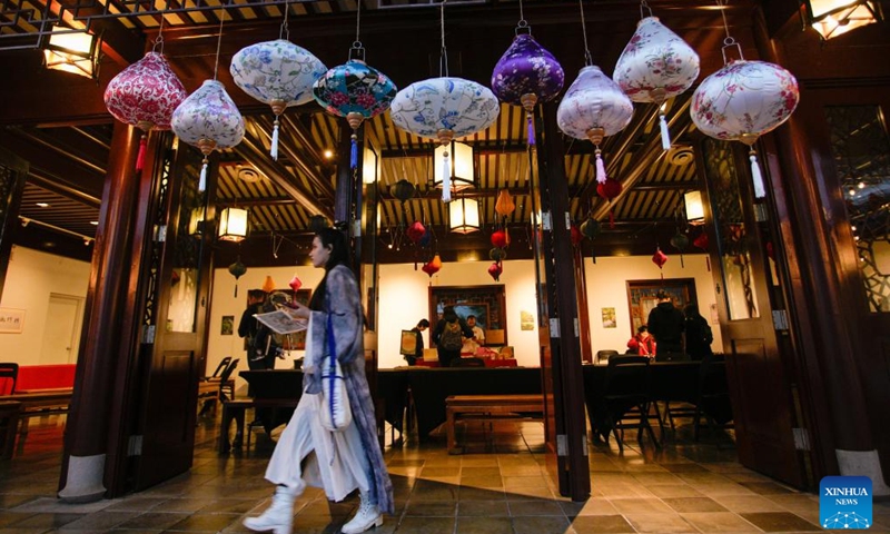A woman walks under lantern displays during a Mid-Autumn Festival event at Dr. Sun Yat-Sen Classical Chinese Garden in Vancouver, British Columbia, Canada, Oct. 5, 2025. (Photo by Liang Sen/Xinhua)

