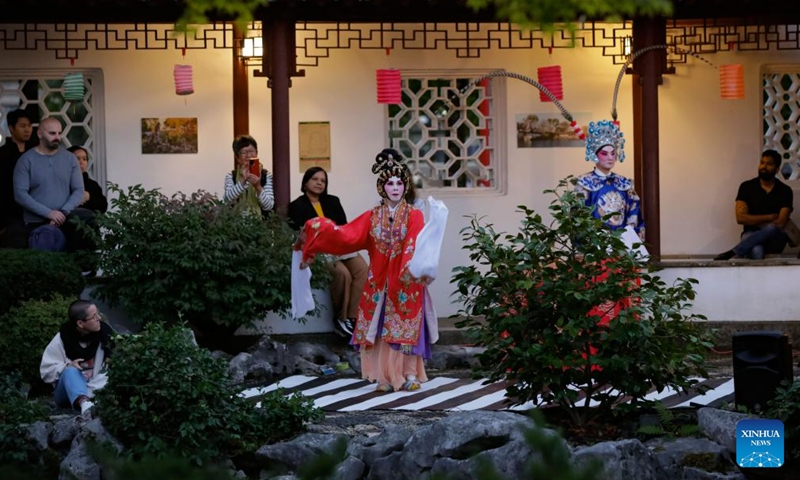 People watch a Cantonese opera performance during a Mid-Autumn Festival event at Dr. Sun Yat-Sen Classical Chinese Garden in Vancouver, British Columbia, Canada, Oct. 5, 2025. (Photo by Liang Sen/Xinhua)

