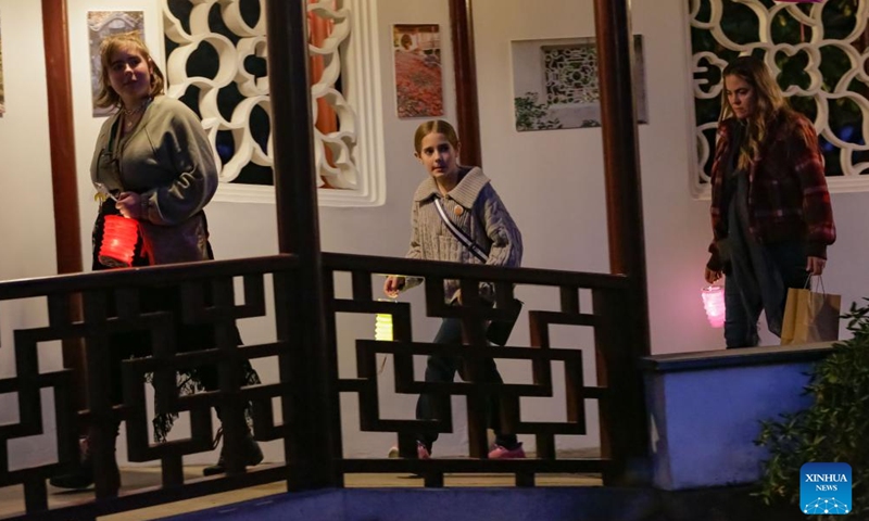 People carry lanterns while attending a Mid-Autumn Festival event at Dr. Sun Yat-Sen Classical Chinese Garden in Vancouver, British Columbia, Canada, Oct. 5, 2025. (Photo by Liang Sen/Xinhua)

