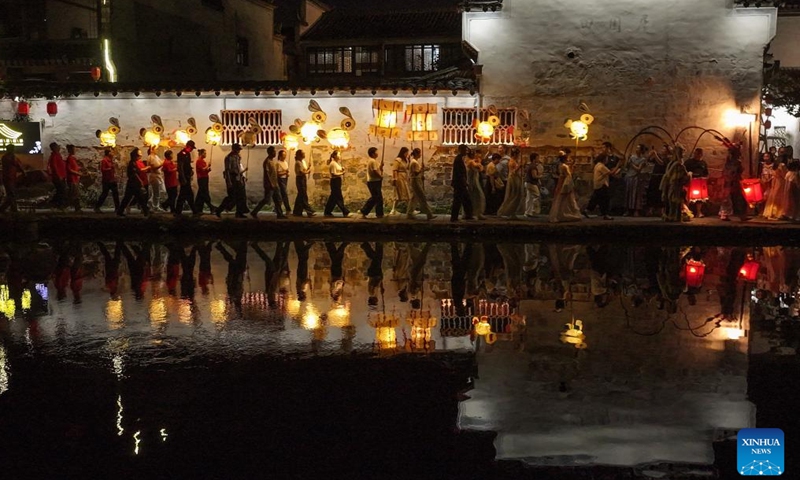 This aerial drone photo taken on Oct. 5, 2025 shows people taking part in a lantern parade at Hongcun Village of Yixian County, Huangshan City, east China's Anhui Province. Yixian County is noted for its lantern gala, an important folk event held during traditional festivals. (Photo by Shi Yalei/Xinhua)