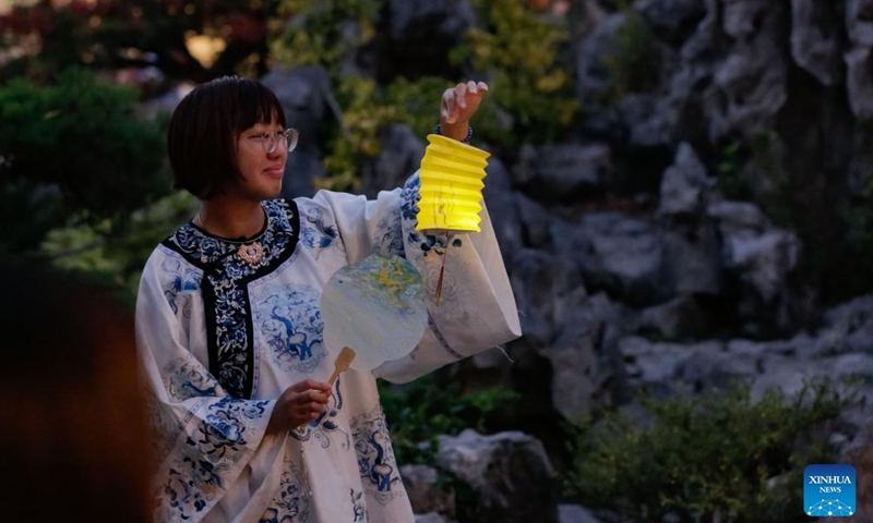 A teenage girl holds a lantern to celebrate the Mid-Autumn Festival at Dr. Sun Yat-Sen Classical Chinese Garden in Vancouver, British Columbia, Canada, Oct. 5, 2025. (Photo by Liang Sen/Xinhua)

