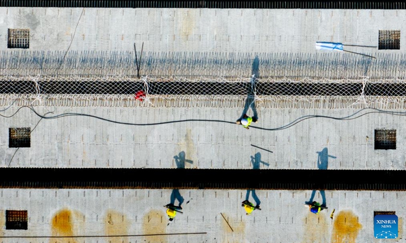 An aerial drone photo taken on Oct. 6, 2025 shows the construction site of a highway in Wuhan, central China's Hubei Province. Many workers have been standing fast at their posts and fulfilling their duties during the eight-day National Day and Mid-Autumn Festival holiday. (Xinhua/Xiao Yijiu)

