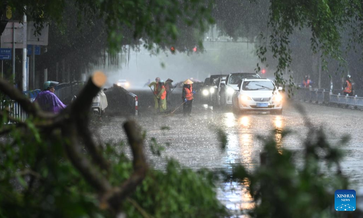 Workers clean up the street in Beihai, south China's Guangxi Zhuang Autonomous Region, Oct. 6, 2025. Typhoon Matmo, the 21st named storm of the 2025 Pacific typhoon season, made landfall along the coast of Guangxi on Monday, bringing strong winds and heavy rainfall. (Photo by Li Junguang/Xinhua)