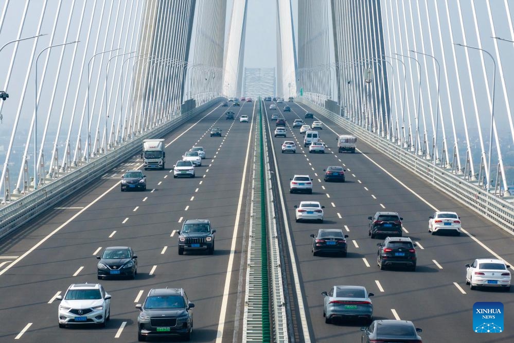 A drone photo taken on Oct. 7, 2025 shows vehicles running on the Changtai Yangtze River Bridge in east China's Jiangsu Province. As the National Day and Mid-Autumn Festival holiday is drawing to a close, return travel flows increase across the country. (Photo by Tang Dehong/Xinhua)