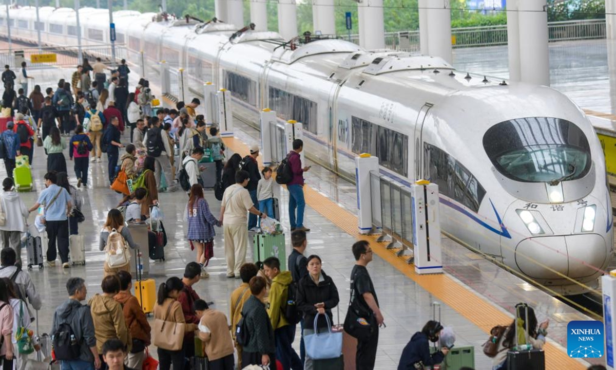 Passengers wait to board a train at Luoyang Longmen Railway Station in Luoyang, central China's Henan Province, Oct. 7, 2025. As the National Day and Mid-Autumn Festival holiday is drawing to a close, return travel flows increase across the country. (Photo by Zhang Yixi/Xinhua)