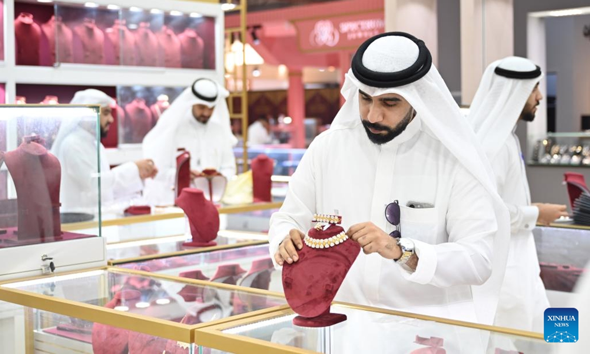 A man displays jewelry during the Gulf International Jewelry Fair (GIJF) in Hawalli Governorate, Kuwait, Oct. 7, 2025. The GIJF opened here on Tuesday and will last until Oct. 12. (Photo by Asad/Xinhua)