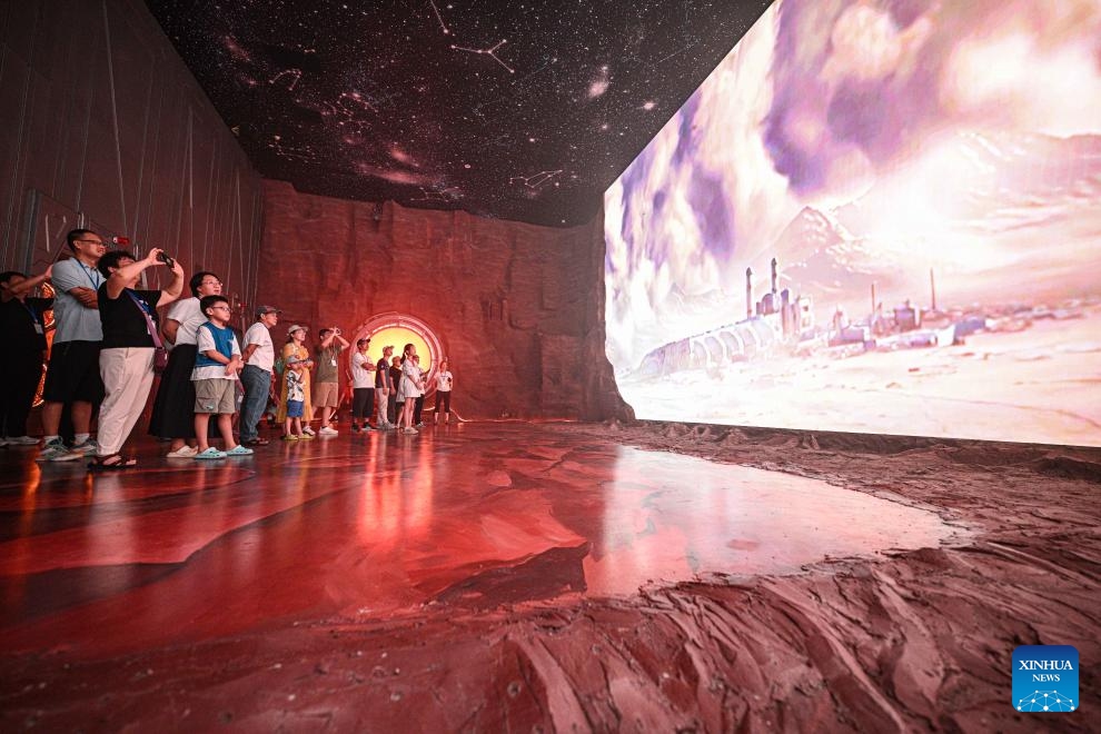 People visit the Wenchang Aerospace Science and Education Center in Wenchang, south China's Hainan Province, Oct. 7, 2025. The upgrade project of the Wenchang Aerospace Science and Education Center is nearing completion. In preparation for its official opening, the center is open to the public free of charge for a limited time, allowing visitors to experience its operation and services firsthand. Following the renovation, the exhibition now features immersive experiences in aerospace history, rocket launches, space science and future exploration. (Xinhua/Pu Xiaoxu)