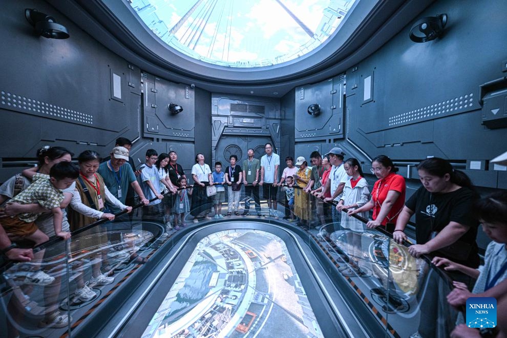 People visit the Wenchang Aerospace Science and Education Center in Wenchang, south China's Hainan Province, Oct. 7, 2025. The upgrade project of the Wenchang Aerospace Science and Education Center is nearing completion. In preparation for its official opening, the center is open to the public free of charge for a limited time, allowing visitors to experience its operation and services firsthand. Following the renovation, the exhibition now features immersive experiences in aerospace history, rocket launches, space science and future exploration. (Xinhua/Pu Xiaoxu)