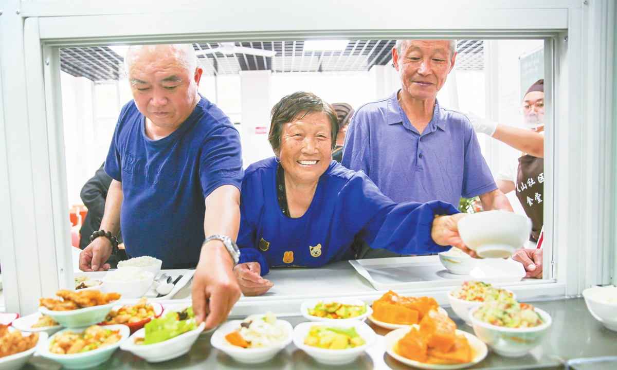 Elderly people select dishes inside a community canteen in Nantong, East China's Jiangsu Province, on June 15, 2025. Photo: VCG