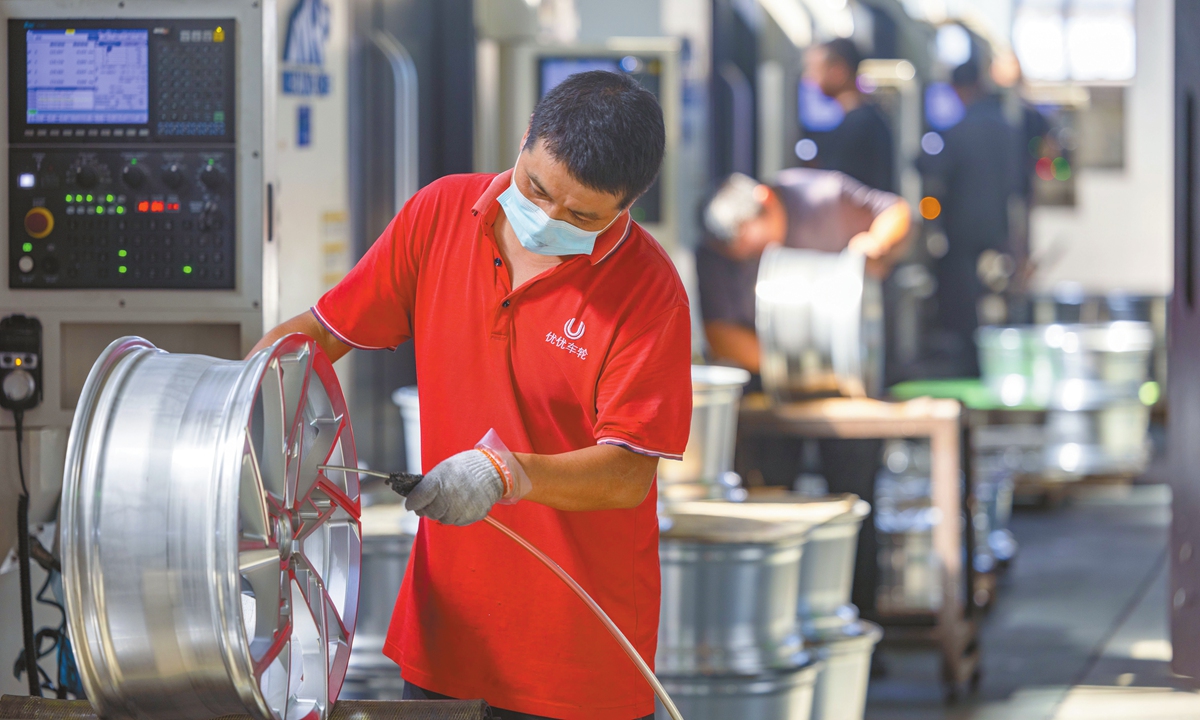 Workers operate on a production line at an auto parts manufacturing company in Taizhou, East China's Jiangsu Province, on October 9, 2025. Local enterprises have resumed full-capacity production following the National Day holiday. Photo：VCG
