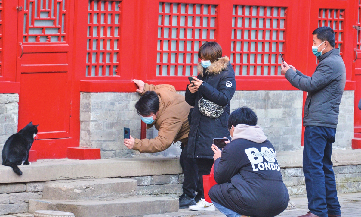 Visitors take pictures of an 