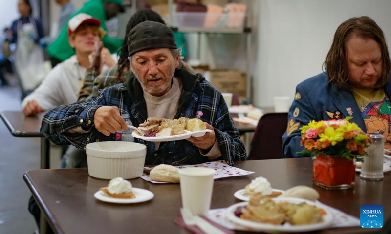 People enjoy Thanksgiving meals at the Union Gospel Mission in Vancouver, British Columbia, Canada, Oct. 10, 2025. The local charity served about 2,000 free meals on Friday to the local residents suffering from unemployment, rising living costs and a lack of affordable housing as part of an early Thanksgiving celebration. Canada's Thanksgiving Day falls on Oct. 13 this year. (Photo: Xinhua)
