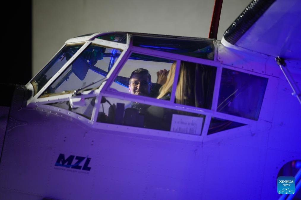 Visitors sit in an aircraft cockpit during an aviation night event in Warsaw, Poland, Oct. 10, 2025. (Photo: Xinhua)