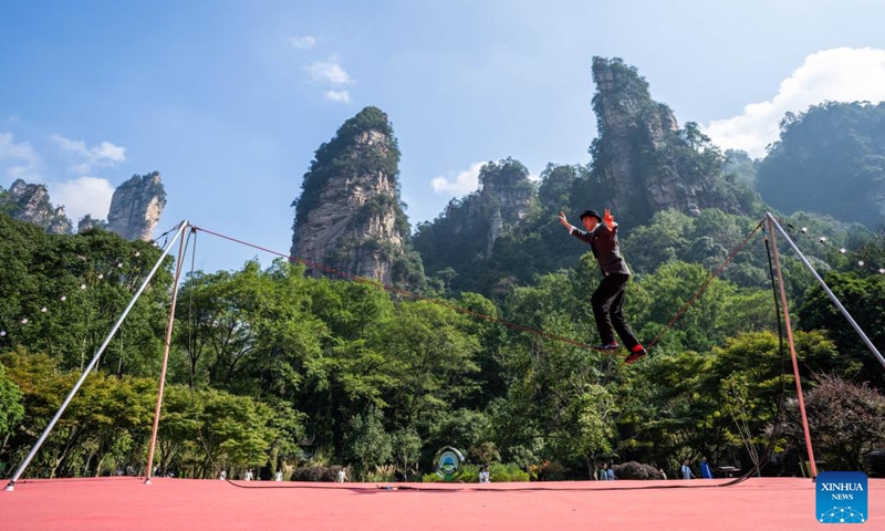 An acrobat from Russia performs during the 2025 Zhangjiajie International New Acrobatic Theater Festival at the Zhangjiajie National Forest Park in Zhangjiajie, central China's Hunan Province, Oct. 11, 2025. The event kicked off in Zhangjiajie on Saturday, with the participation of acrobats from more than ten countries and regions including France, Russia, Germany, Italy, and Chile. Over 60 shows will be presented during the five-day event, integrating elements of drama, dance, music, and new media. (Photo: Xinhua)