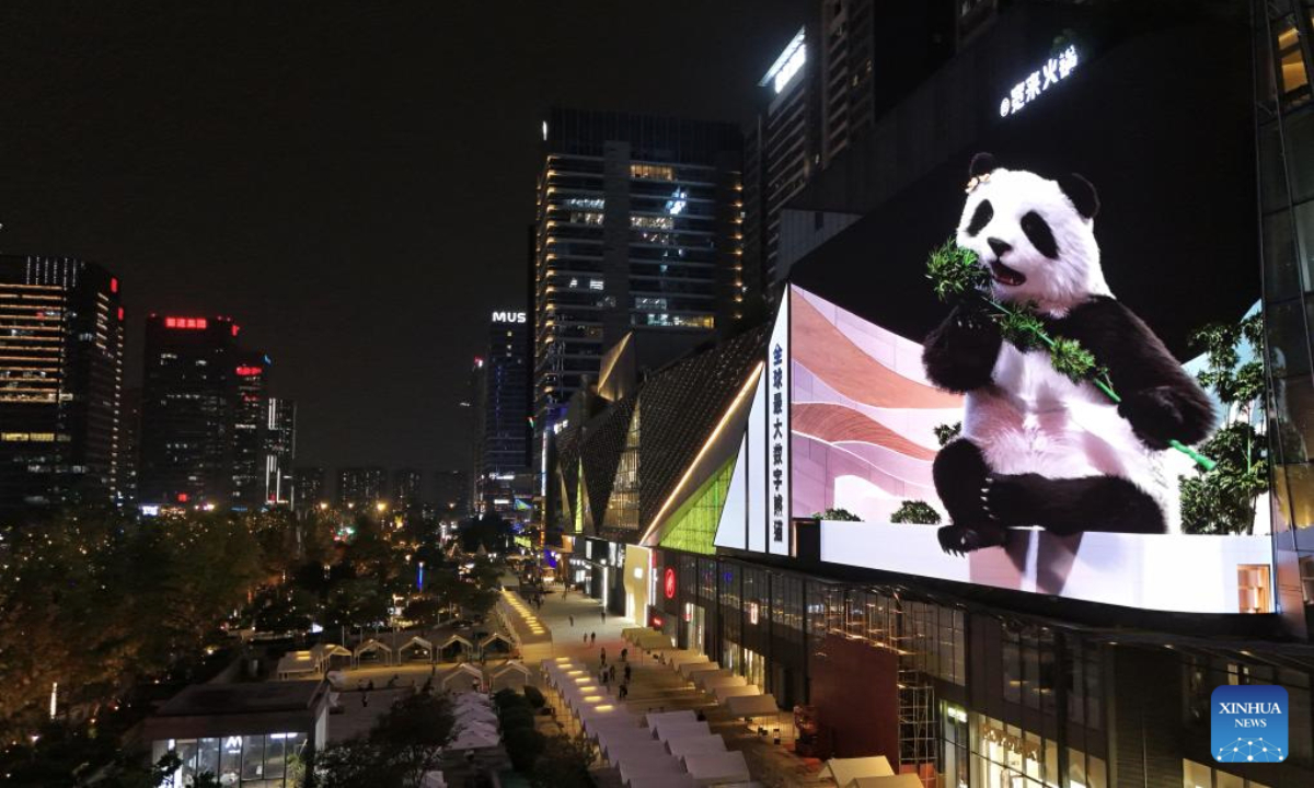 A drone photo taken on Oct. 14, 2025 shows a glasses-free 3D panda along a street in Chengdu, southwest China's Sichuan Province. The glasses-free 3D pandas here have won the hearts of both residents and tourists since its debut in 2024, becoming a must-visit spot in the city. (Xinhua/Liu Kun)