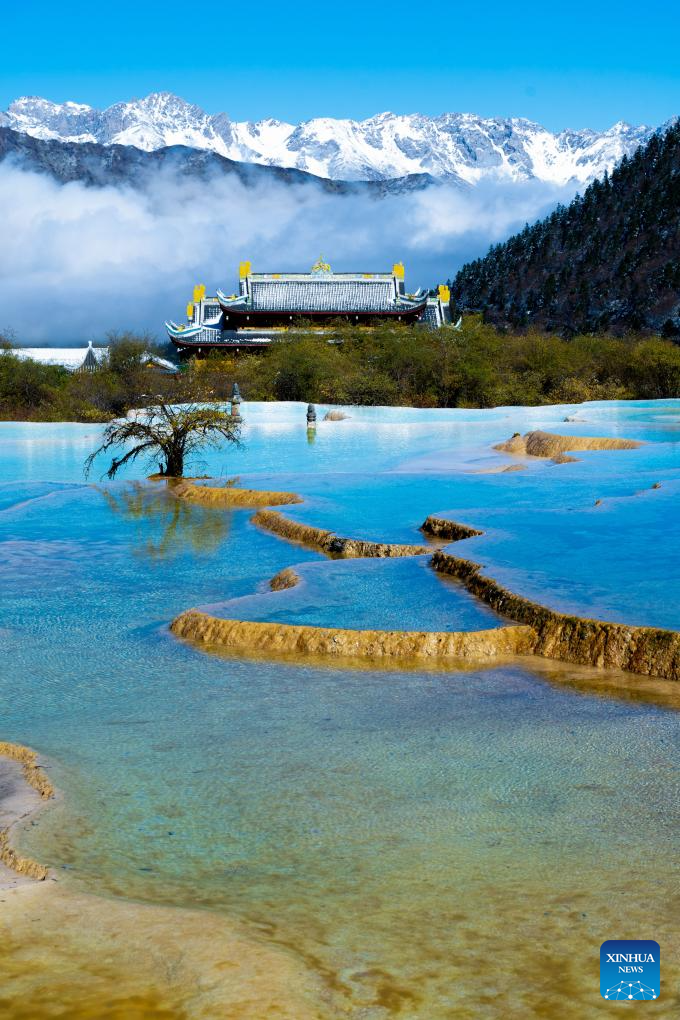A drone photo taken on Oct. 21, 2025 shows a view of a colorful pond cluster after snow at the Huanglong scenic area in Aba Tibetan and Qiang Autonomous Prefecture, southwest China's Sichuan Province.

Huanglong witnessed the first snowfall of this autumn on Tuesday. (Photo by Sun Jiapeng/Xinhua)