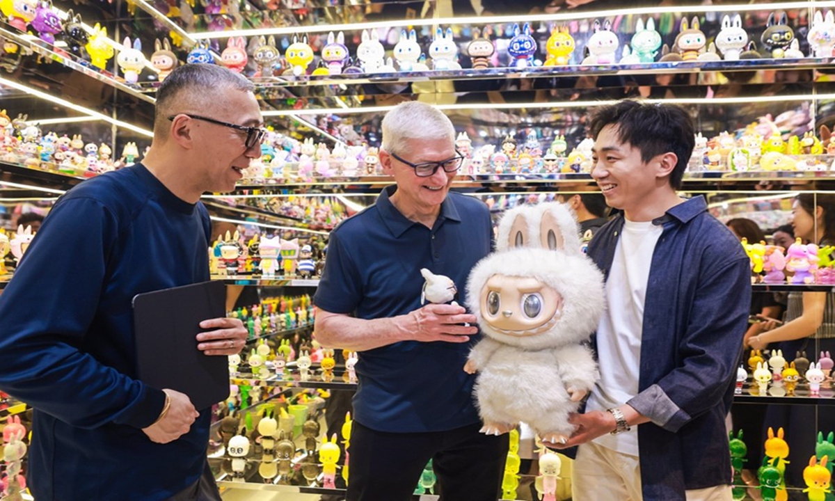 Apple CEO Tim Cook receives a gift — LABUBU, from Wang Ning, the founder and CEO of Pop Mart, during THE MONSTERS exhibition in Shanghai on October 13, 2025. Photo: courtesy of Pop Mart